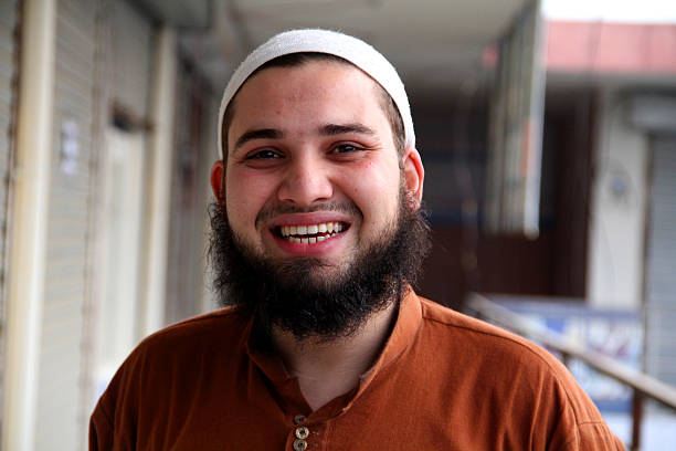 smiling south asian bearded male